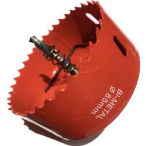 Close-up of a red hole saw attachment with serrated rim and central spiral drill bit